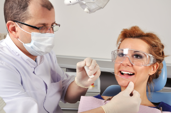 dentist cleans teeth