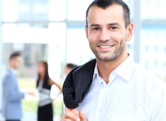 Handsome confident young businessman, smiling happy, looking at camera